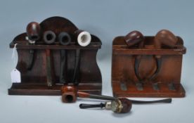 A small group of vintage smoking tobacco pipes of varying sizes with some having bakelite