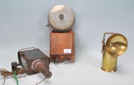 A vintage 20th century Industrial alarm bell together with a brass lamp of cylindrical form and a
