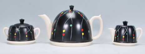 A retro vintage ceramic and aluminium tea set comprising of a teapot, creamer and sugar bowl each