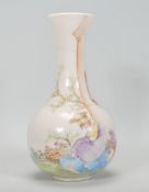 An early 20th Century vase of bulbous form having a tall flared neck having a white ground hand