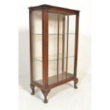 An early 20th Century Art Deco walnut display china cabinet, glazed single door with flanked by
