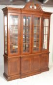 A Victorian style fruitwood breakfront library triple display cabinet bookcase on cupboard, the
