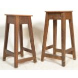 A pair of early 20th century church vestry stools of wooden construction raised on squared legs