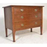 An early 20th Century Arts and Crafts oak chest of drawers, three straight drawers fitted with brass