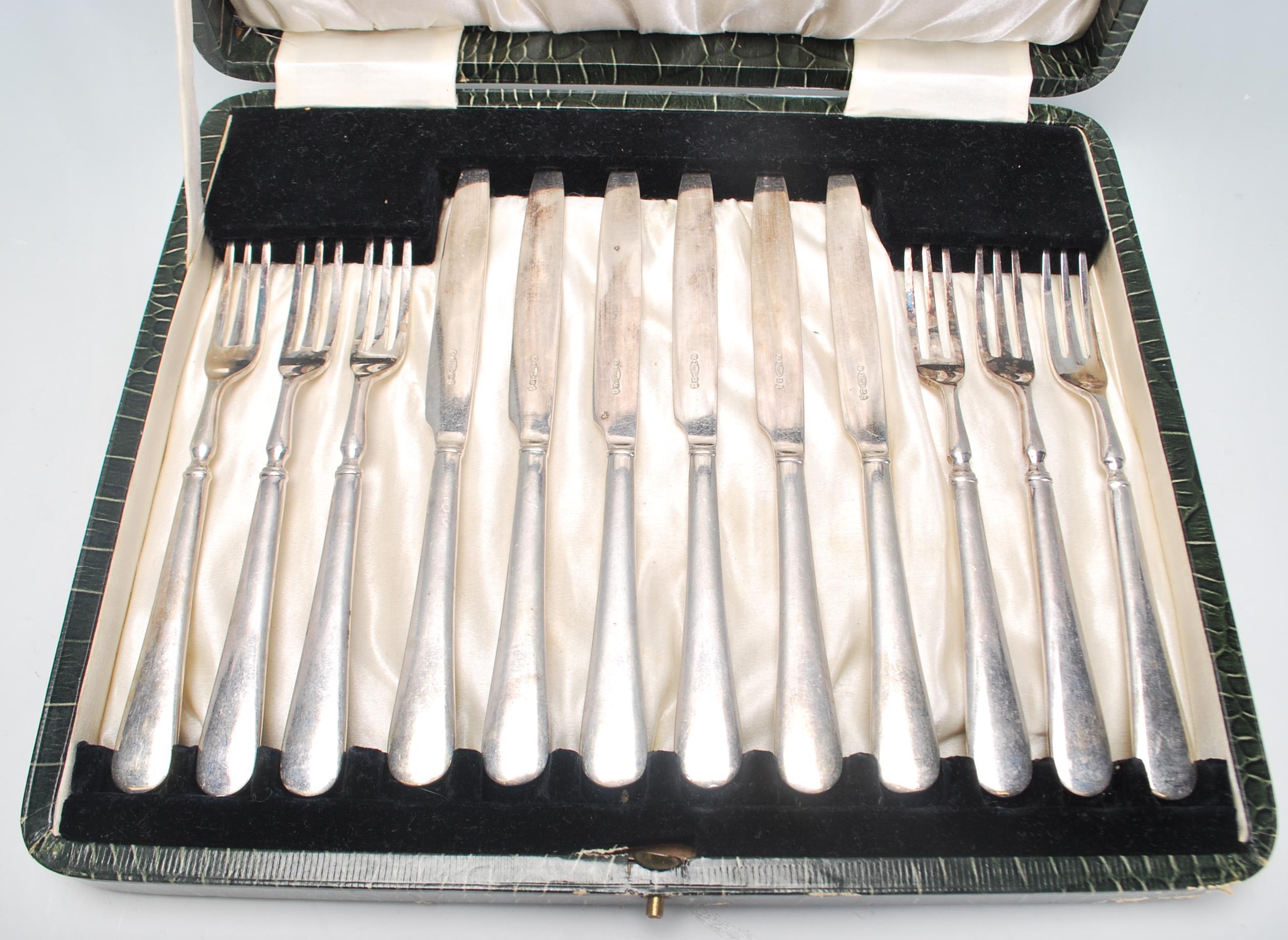 A vintage silver plated cake knife and fork set consisting of six knives and forks set within its - Image 2 of 9