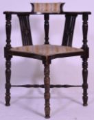 A late 19th century mahogany corner chair with pierced and carved splats raised on turned supports
