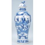 A 19th Century Chinese lidded vase of baluster form having a hand painted blue and white prunus