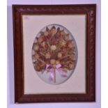 An early to mid 20th Century framed and glazed dried floral bouquet / garland interspersed with