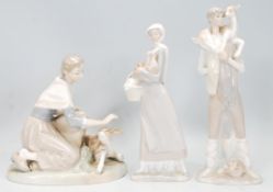 A good group of three Lladro porcelain figures to include a lady with a young calf, a man carrying a