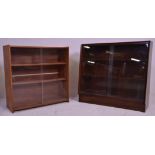 Two vintage 20th Century closed teak bookcase shelving units each having two shelves with glazed