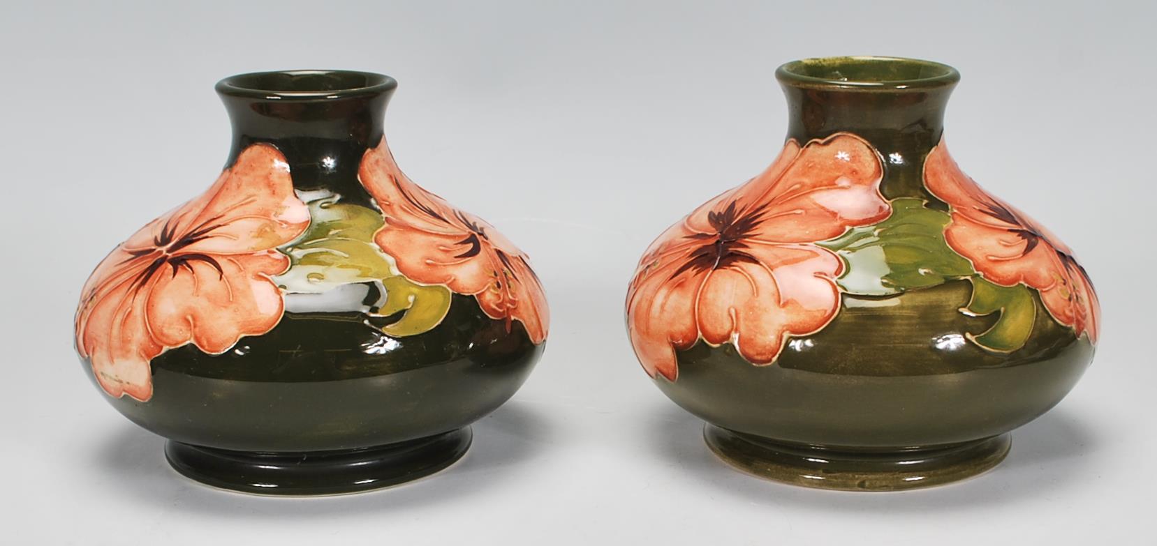 Walter Moorcroft - A pair of Moorcroft tubelined Hibiscus pattern vases of squat globular form - Image 2 of 6