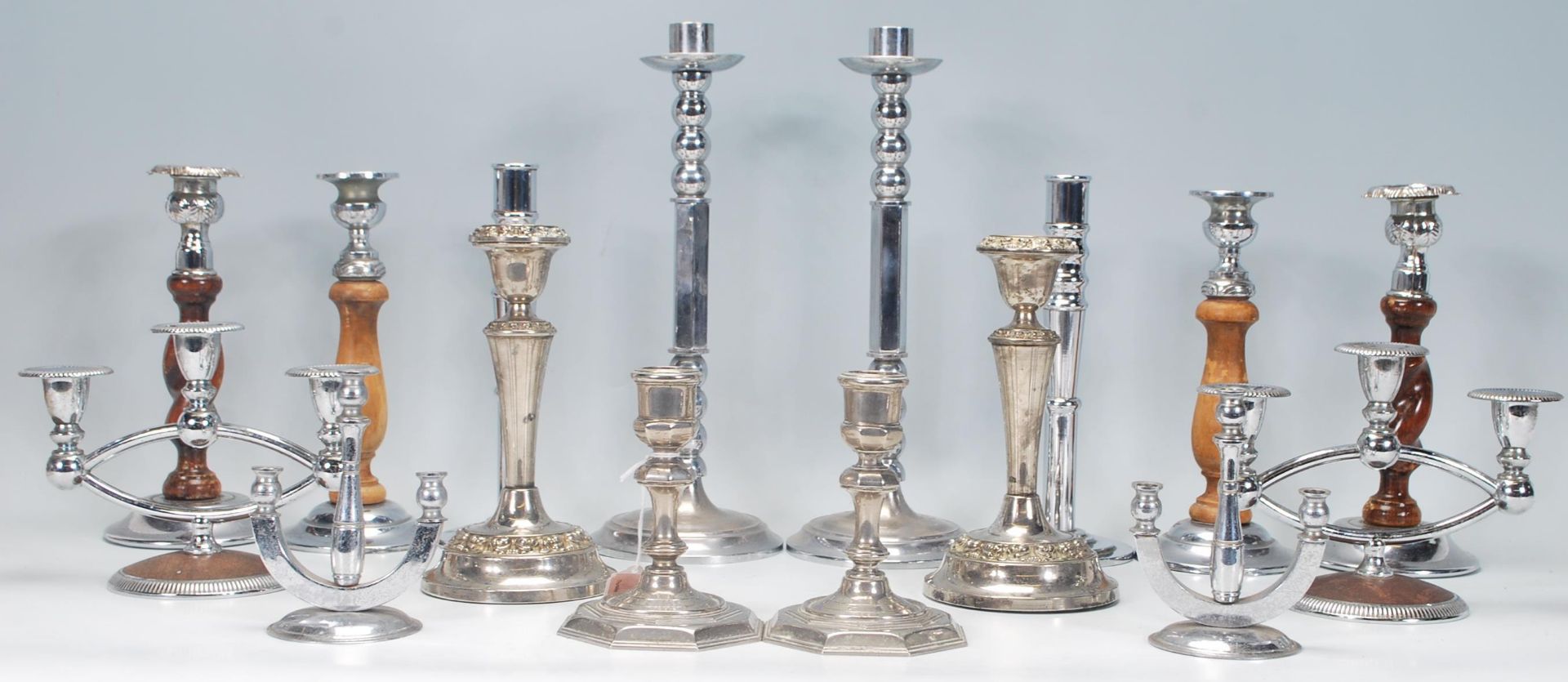 A good group of early 20th Century Art Deco candlesticks in matching pairs to include a heavy pair