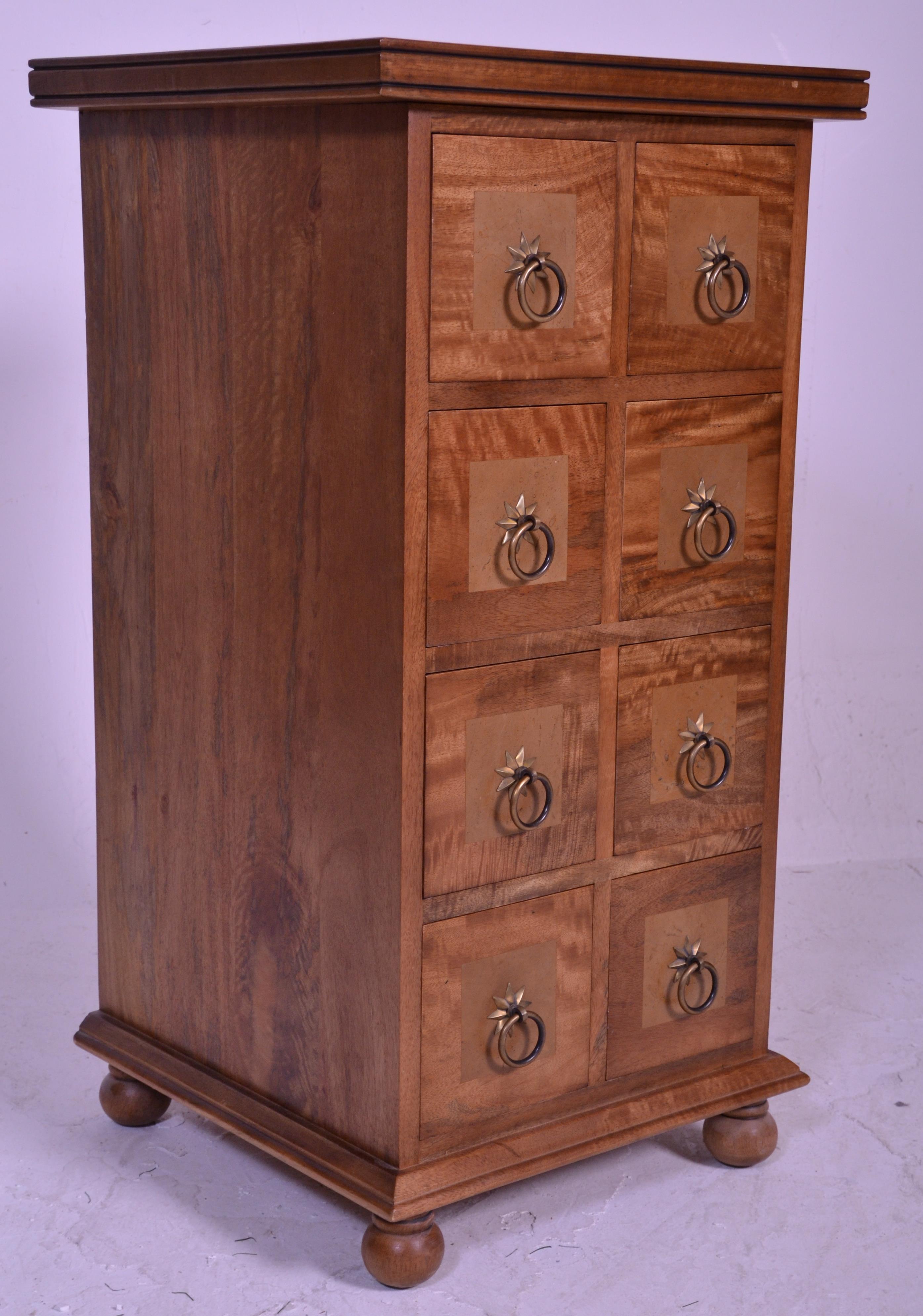 A contemporary 20th century hardwood inlaid pedestal merchants chest of drawers. Raised on bun