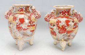 A matching pair of early 20th Century Japanese Kuitan ware having hand painted oriental scene and