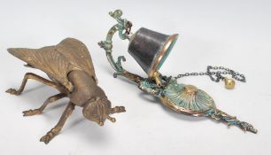 A vintage 20th Century brass ashtray in the form of a blue bottle fly, the wings lifting to reveal