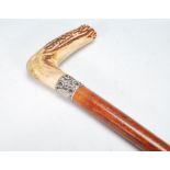 A 19th Century Victorian malacca walking stick cane having a horn handle to the top and a silver