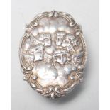 A vintage 20th Century silver hallmarked pill box / pot of oval form having repousse winged cherub
