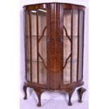 A 1940's Queen Anne revival walnut demi-lune half moon china display cabinet. Raised on cabriole