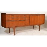 A mid century Danish inspire teak wood sideboard credenza being raised on tapering legs with  a