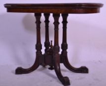 A 19th Century Victorian Aesthetic movement walnut foldover card table having a rounded inlaid top