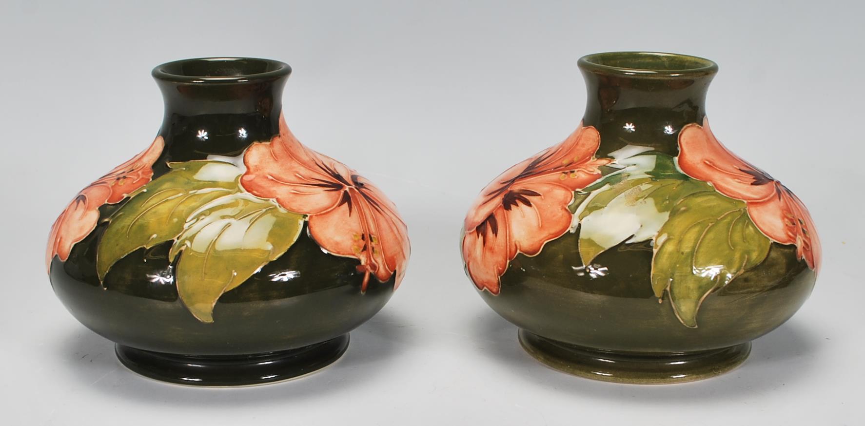 Walter Moorcroft - A pair of Moorcroft tubelined Hibiscus pattern vases of squat globular form - Image 3 of 6