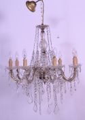 A good 20th century 8 arms cristal chandelier having faceted drops, gilded power cable and candle