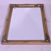 A contemporary gilt frame wall mirror with central bevelled edge glass mirror panel to centre having