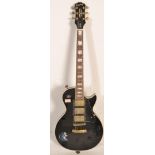 A Gibson Epiphone electric guitar 'Black Beauty' Les Paul solid body. The black body having white