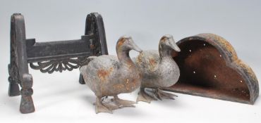 A pair of 20th century bronze ducks - garden ornaments together with a cast iron boot scrape, a cast