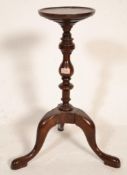 A 19th Century mahogany plant torchere / kettle stand raised on a tripod base with turned central