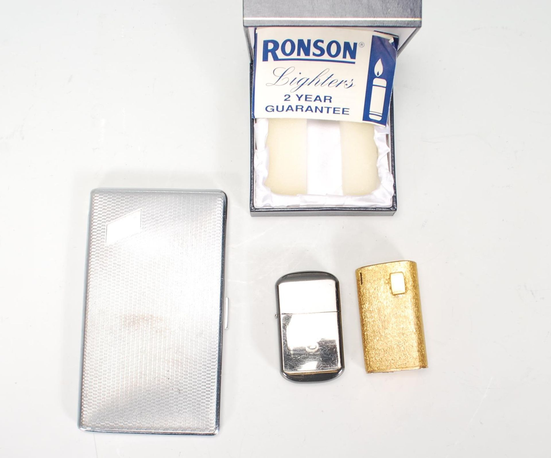 A vintage mid 20th Century Ronson 15V cigarette lighter having a gilt finish of curved triangular - Image 2 of 6
