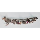 An English silver hallmarked charm bracelet having a curb link chain with 25 charms to include a