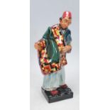 A Royal Doulton 'Carpet Seller' HN 1464 figurine modelled in the form of a man showing a carpet