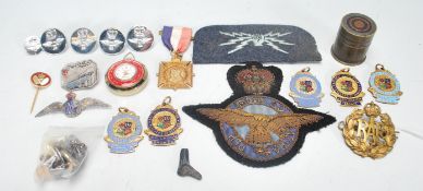 A collection of vintage 20th Century enamelled and military badges ro include RAF patches and