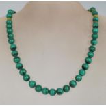 A 20th Century vintage malachite beaded necklace with round beads and a spring ring clasp.