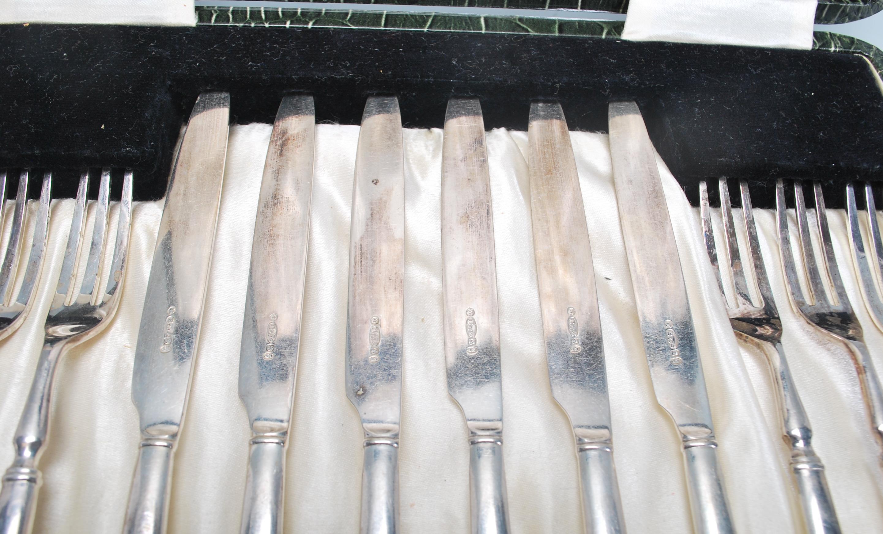 A vintage silver plated cake knife and fork set consisting of six knives and forks set within its - Image 4 of 9