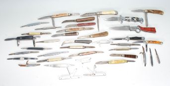 A collection of pocket knives of varying sizes and designs to include a Good Year advertising