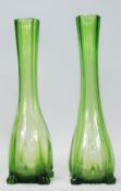 A pair of early 20th Century Art Deco green glass vases having slender necks with bulbous bases