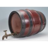 A mid 20th Century wooden and metal bound coppered barrel having lacquered body a brass tap.