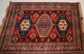 A good vintage Persian Islamic floor rug / carpet having red ground with blue and cream geometric