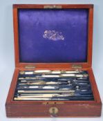 A late 19th Century wooden cased draughtsman set having a fitted blue velvet lined interior complete