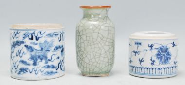 A group of three Chinese ceramic ornaments to include a blue and white pot of cylindrical form being