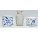 A group of three Chinese ceramic ornaments to include a blue and white pot of cylindrical form being