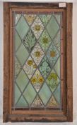 A 19th Century Victorian stained glass window having leaded glass panels decorated with floral