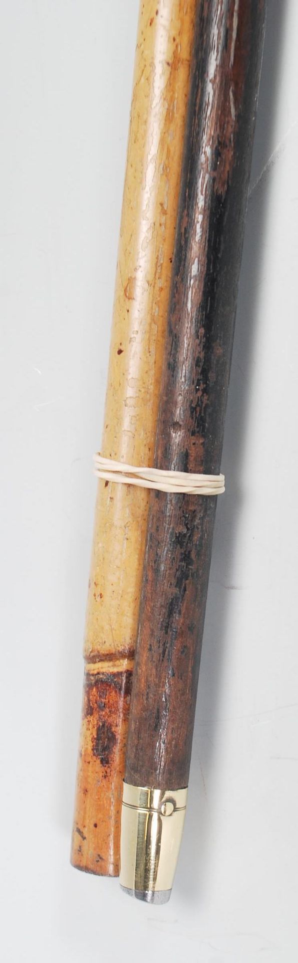 A pair of 20th century wooden walking sticks havin - Image 9 of 9