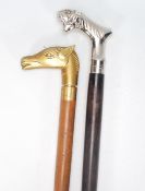 A 20th Century walking stick cane having a tapering wooden shaft with a brass handle to the top