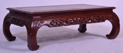 A large 20th century Chinese coffee table, having bow shaped legs and pierced dragon decoration.