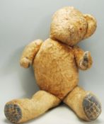 A vintage early to mid 20th Century childs teddy bear constructed from mohair with leather patches