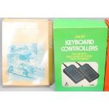 A collection of vintage original Atari handheld video games and keyboard controllers including