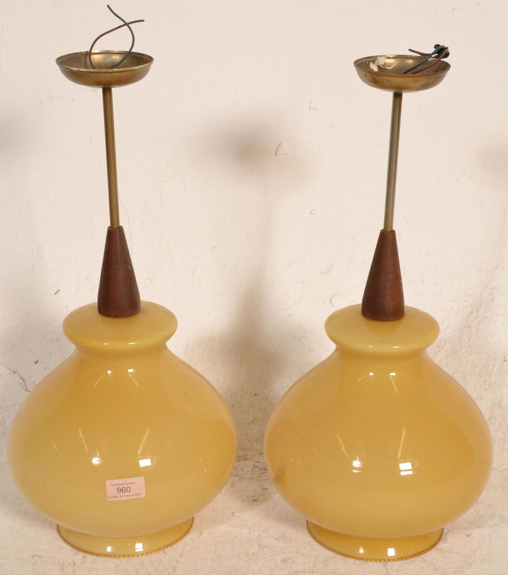 A pair of mid century teak wood and amber glass ce